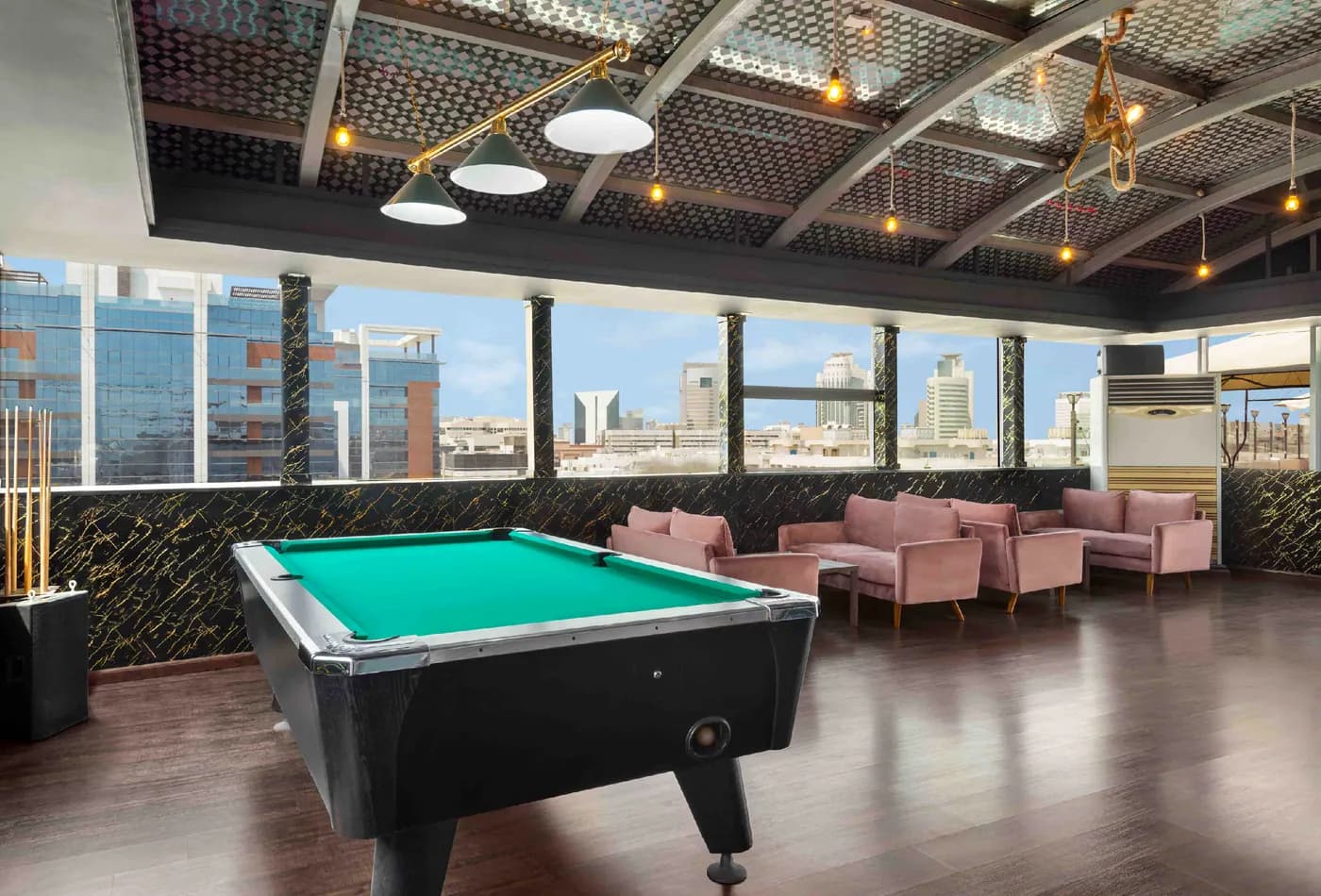 The rooftop lounge with a pool table and city views